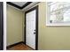 This entryway has a white door with black hardware and a window providing natural light at 1802 S Gordon Sw St, Atlanta, GA 30310