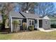 Charming gray brick house with a well-maintained lawn, bright white trim, and a vibrant blue front door at 1802 S Gordon Sw St, Atlanta, GA 30310