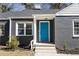 Close up of a gray brick house with a bright blue front door and clean white trim at 1802 S Gordon Sw St, Atlanta, GA 30310