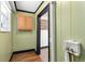 Hallway area with hardwood floors, neutral green walls, and access to additional rooms at 1802 S Gordon Sw St, Atlanta, GA 30310