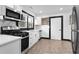 Modern kitchen featuring stainless steel appliances, white cabinets, marble backsplash, and black accents at 1802 S Gordon Sw St, Atlanta, GA 30310