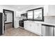Well-lit kitchen showcasing stainless steel appliances, white cabinets, marble backsplash, and black accents at 1802 S Gordon Sw St, Atlanta, GA 30310