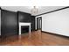 Spacious living room featuring dark accent walls, a fireplace, and hardwood floors at 1802 S Gordon Sw St, Atlanta, GA 30310