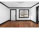 Bright living room features hardwood floors, black trim, and a door and window letting in natural light at 1802 S Gordon Sw St, Atlanta, GA 30310