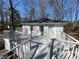 An outside view of a back deck with white railing, windows, and door at 5718 Denson Blvd, Morrow, GA 30260