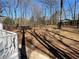 An expansive backyard view showing a lush, natural landscape with mature trees and a patio at 5718 Denson Blvd, Morrow, GA 30260