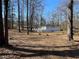 The expansive backyard has mature trees providing shade and a natural setting for outdoor enjoyment at 5718 Denson Blvd, Morrow, GA 30260