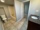 Bathroom with tile flooring, granite vanity, and tub/shower at 5718 Denson Blvd, Morrow, GA 30260