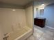 Simple bathroom with tiled floors, tub/shower combo, and modern vanity at 5718 Denson Blvd, Morrow, GA 30260