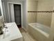 Bright bathroom features a double sink, soaking tub, and walk-in closet at 5718 Denson Blvd, Morrow, GA 30260