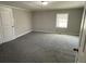Spacious carpeted bedroom filled with natural light from a window at 5718 Denson Blvd, Morrow, GA 30260