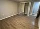 Bedroom with wood-look floors and closet with mirrored doors at 5718 Denson Blvd, Morrow, GA 30260