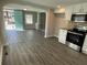Bright kitchen with new stainless steel appliances, cabinets, and a view into the living area at 5718 Denson Blvd, Morrow, GA 30260