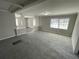 Open-concept living room with a fireplace, new paint, large windows and a view of the entry at 5718 Denson Blvd, Morrow, GA 30260
