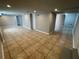 Large living room with tile floors and neutral gray walls at 5718 Denson Blvd, Morrow, GA 30260