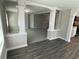 Open living area with fresh gray carpet and paint. It looks into the kitchen and entry at 5718 Denson Blvd, Morrow, GA 30260