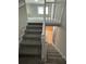 Carpeted staircase with white railing leads to the upper and lower levels at 5718 Denson Blvd, Morrow, GA 30260