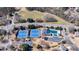 Aerial view showcasing community amenities including a swimming pool and tennis courts at 7350 Brassfield Dr, Cumming, GA 30041