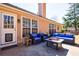 Backyard patio with modern furniture and a grill, creating an inviting outdoor living space at 7350 Brassfield Dr, Cumming, GA 30041