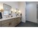 Bright bathroom features a spacious double vanity and decorative mirrors and lighting at 7350 Brassfield Dr, Cumming, GA 30041