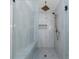 Modern bathroom shower featuring sleek tile, glass partition, and bronze fixtures for a luxurious feel at 7350 Brassfield Dr, Cumming, GA 30041