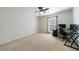 Bedroom with a neutral carpet, a ceiling fan, and a desk setup, ideal for a home office at 7350 Brassfield Dr, Cumming, GA 30041