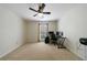Bedroom with a neutral carpet, a ceiling fan, and a desk setup, ideal for a home office at 7350 Brassfield Dr, Cumming, GA 30041