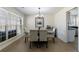 Dining room with six upholstered chairs, glass tabletop, and natural light at 7350 Brassfield Dr, Cumming, GA 30041