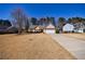Attractive single-story home featuring a spacious front yard, an attached two-car garage, and tidy landscaping at 7350 Brassfield Dr, Cumming, GA 30041
