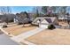 Charming single-story home with a well-maintained lawn, an attached two-car garage, and a long driveway at 7350 Brassfield Dr, Cumming, GA 30041