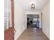 Inviting foyer featuring hardwood floors, a decorative light fixture, and a view into the adjacent living space at 7350 Brassfield Dr, Cumming, GA 30041
