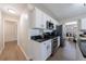 Well-equipped kitchen features stainless steel appliances, black granite countertops, and white cabinets at 7350 Brassfield Dr, Cumming, GA 30041