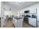 Bright kitchen features white cabinets, black countertops, and a stainless steel oven at 7350 Brassfield Dr, Cumming, GA 30041