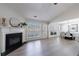Spacious living room with a fireplace and views into the dining area at 7350 Brassfield Dr, Cumming, GA 30041