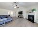 Comfortable living room showcases a fireplace, gray sectional, and natural light at 7350 Brassfield Dr, Cumming, GA 30041