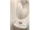 Powder room with oval mirror over a pedestal sink, exuding simple sophistication at 175 Stillwood Dr, Fayetteville, GA 30215