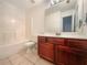 Bathroom featuring a tub/shower combination, a dark wood vanity, and light tile flooring at 175 Stillwood Dr, Fayetteville, GA 30215