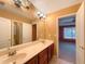 Spacious bathroom featuring double sinks, vanity, and entrance to another bedroom at 175 Stillwood Dr, Fayetteville, GA 30215