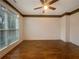Neutral bedroom boasts hardwood floors, a large window and a ceiling fan at 175 Stillwood Dr, Fayetteville, GA 30215