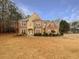 Traditional two-story brick home featuring manicured landscaping and a symmetrical facade at 175 Stillwood Dr, Fayetteville, GA 30215