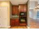 Kitchen with wooden cabinets, built-in oven, and view to the living room at 175 Stillwood Dr, Fayetteville, GA 30215