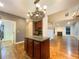 Open kitchen and living space with an island and views of the fireplace at 175 Stillwood Dr, Fayetteville, GA 30215