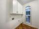 Laundry room with cabinets, tile floor, and window for natural light at 175 Stillwood Dr, Fayetteville, GA 30215