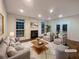 Staged living room with a cozy fireplace, plush seating, and bright natural light at 175 Stillwood Dr, Fayetteville, GA 30215