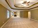 Spacious main bedroom with tray ceilings, fireplace and multiple windows at 175 Stillwood Dr, Fayetteville, GA 30215
