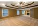 Large main bedroom features tray ceilings, a fireplace and multiple windows at 175 Stillwood Dr, Fayetteville, GA 30215
