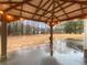 Covered patio featuring string lights and a view of the expansive backyard at 175 Stillwood Dr, Fayetteville, GA 30215