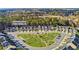 Aerial view of townhomes and a meticulously landscaped common area in a peaceful, wooded Powder Springs, GA neighborhood at 5620 Berney Cir, Powder Springs, GA 30127