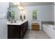 Bright bathroom featuring a double vanity, soaking tub and modern fixtures at 5620 Berney Cir, Powder Springs, GA 30127