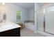 Bright bathroom featuring a double vanity, soaking tub and glass shower at 5620 Berney Cir, Powder Springs, GA 30127